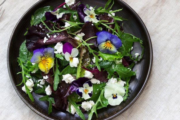 Salad of pansies and herbs seasoned with vegetable oil, lemon juice and spices.