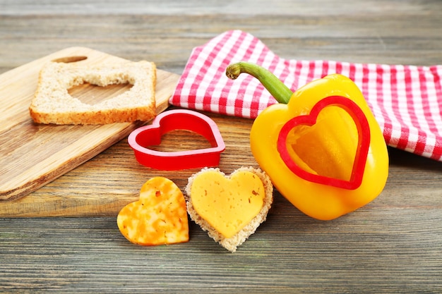 Salad pepper with cut in shape of heart and cheese on table close up