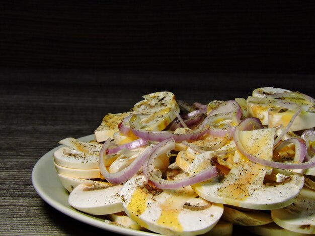 Salad of raw mushrooms with a blue onions.