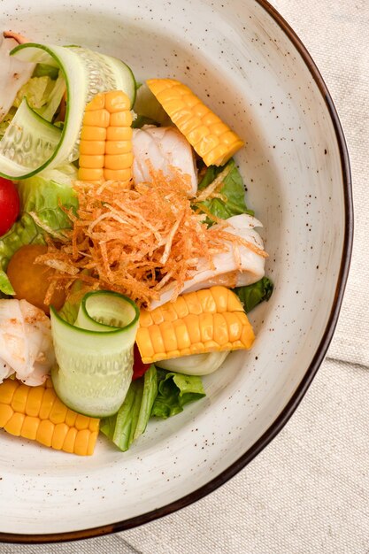 Salad salad of fresh vegetables on a white wooden background top view