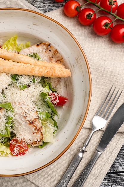 Salad salad of fresh vegetables on a white wooden background top view