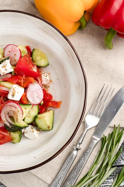 Salad salad of fresh vegetables on a white wooden background top view