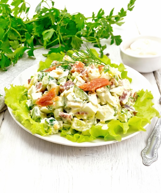 Salad of salmon and avocado with mayonnaise on board
