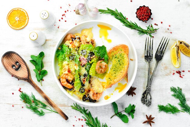 Salad of shrimp olives pine nuts and lettuce Top view Free space for text