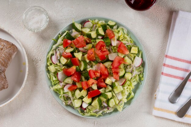 トマトとキュウリのサラダとさまざまな生野菜とオリーブオイルヘルシーなベジタリアン料理