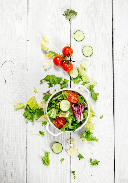 Salad of tomatoes and cucumbers with fresh greens.