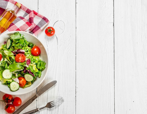 Salad of tomatoes and cucumbers with greens