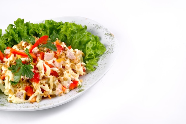 Salad trends. Salad with ham, paprika, pepper and cheese on a white isolated background.