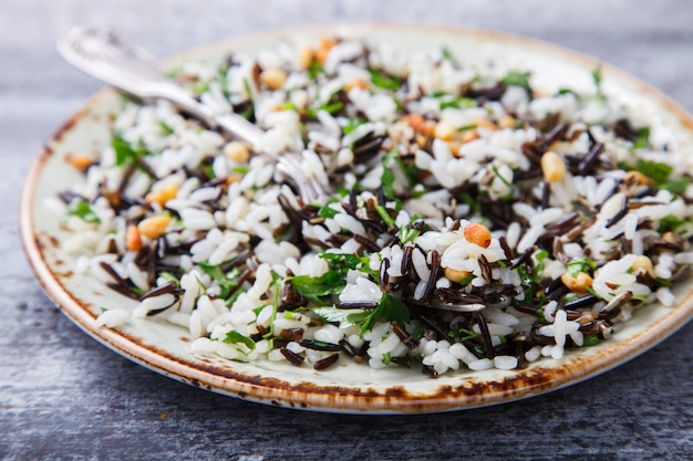 Salad of white and wild rice with pine nuts and herbs
