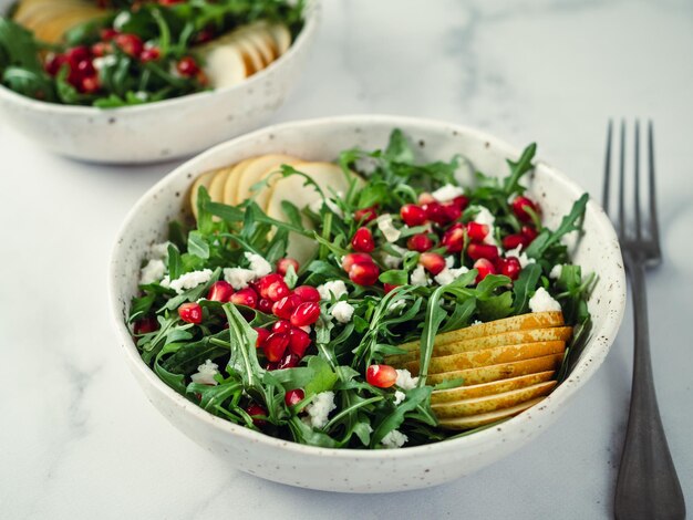 Photo salad with arugula pear pomegranate and cheese