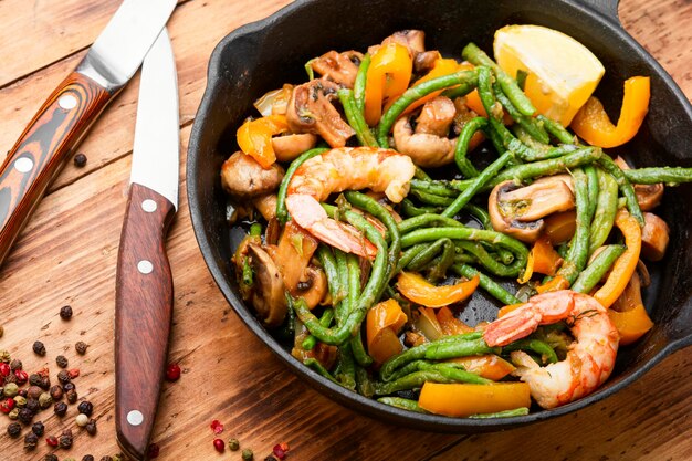 Salad with atlantic shrimps and asparagus beans.Stew with seafood and vegetables.