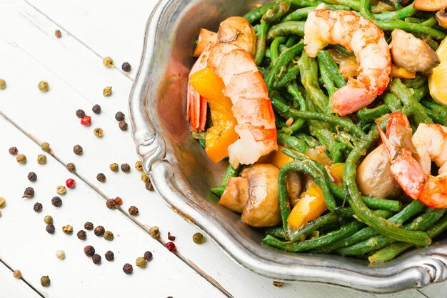 Salad with atlantic shrimps and asparagus beans.Stew with seafood and vegetables.