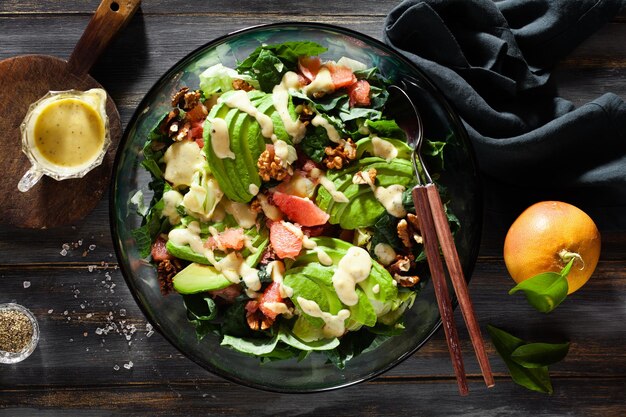 Salad with avocado and grapefruit on a dark blue wooden