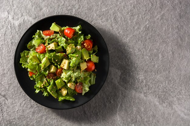 Salad with avocado, lettuce, tomato and flax seeds