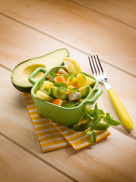 Salad with avocado surimi and pineapple