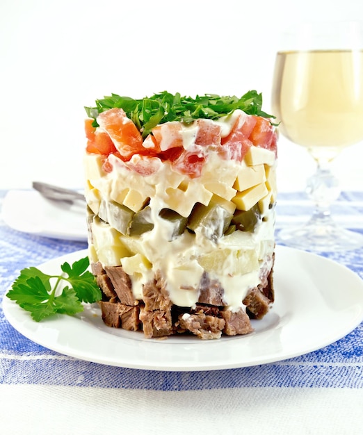 Salad with beef and tomato on tablecloth