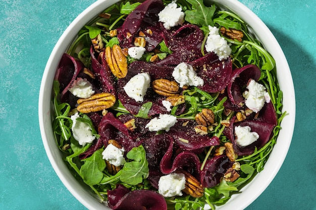 Photo salad with beets arugula and farm sheep's cheese with nuts and balsamic sauce summer recipe