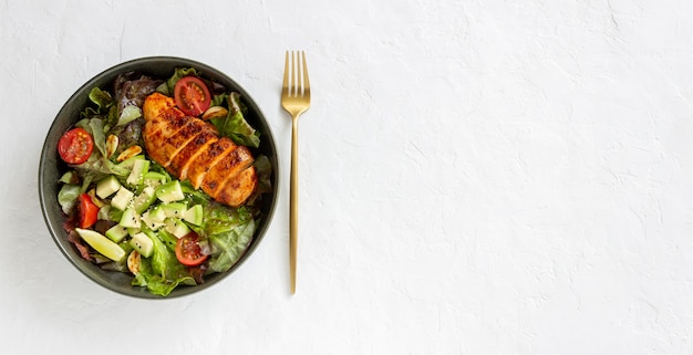 Salad with chicken, avocado and tomatoes. Healthy eating. Vegetarian food.