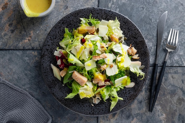 Salad with chicken chunks served on plate. Closeup