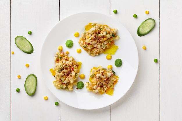 Salad with crab meat cucumbers and corn on cheese chips