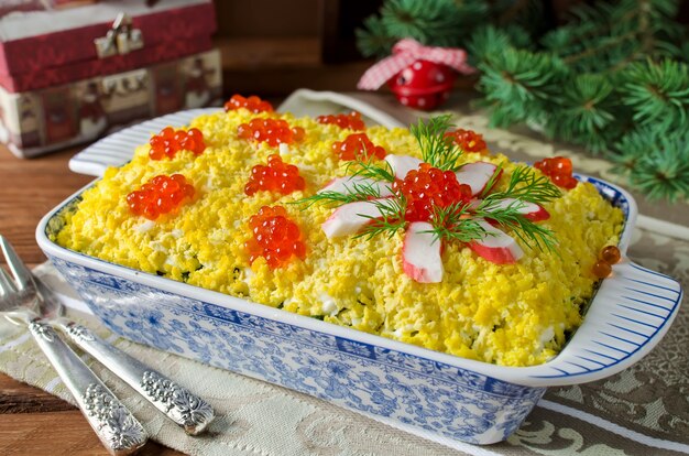 Salad with crab sticks decorated with red caviar