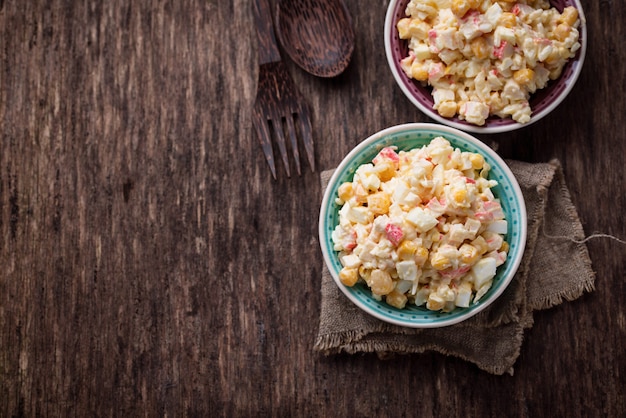 Salad with crab sticks, rice and corn