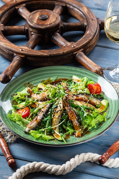 Salad with eel and grilled avocado