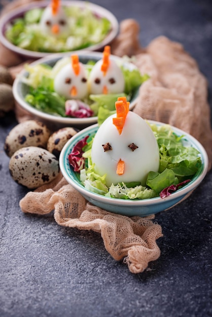 Salad with eggs in shape of chickens. Festive food.