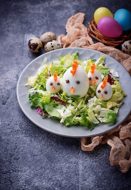 Salad with eggs in shape of chickens. Festive food.