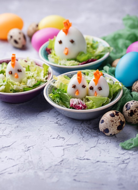 Salad with eggs in shape of chickens. Festive food.