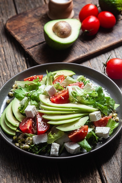 Salad with feta cheese avocado and tomatoes in a bowl