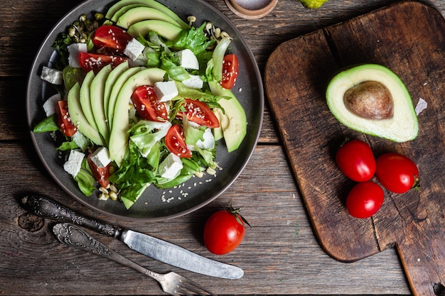 Salad with feta cheese avocado and tomatoes in a bowl