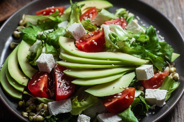 Salad with feta cheese avocado and tomatoes in a bowl
