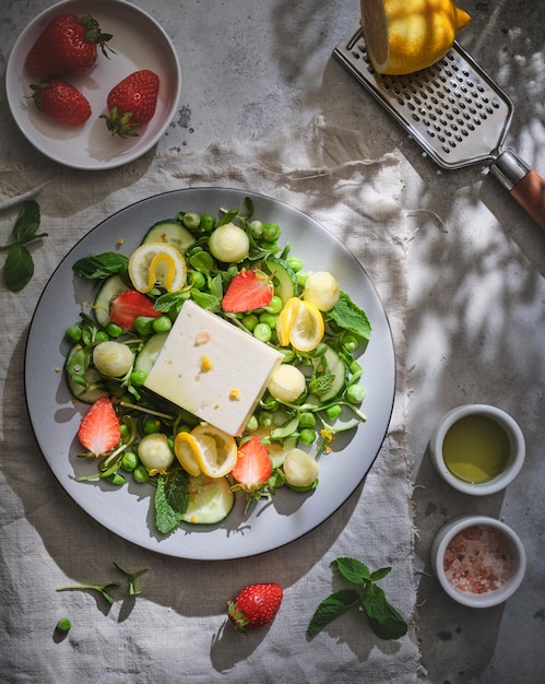 Salad with feta mint melon strawberries lemon and green peas Fresh summer salad Vegetarian salad