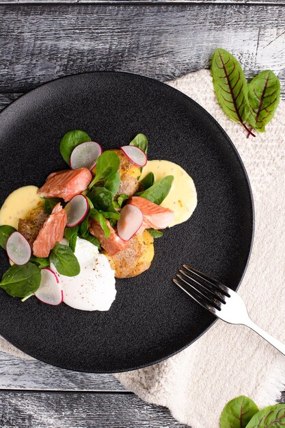 Salad with fish salad with fish on a white wooden background\
top view