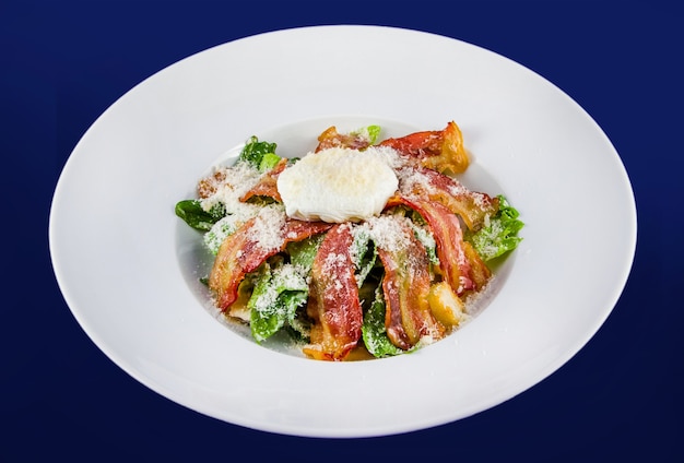 Salad with fragrant breadcrumbs, bacon, parmesan and fresh leaves lettuce, dressed with soft cheese