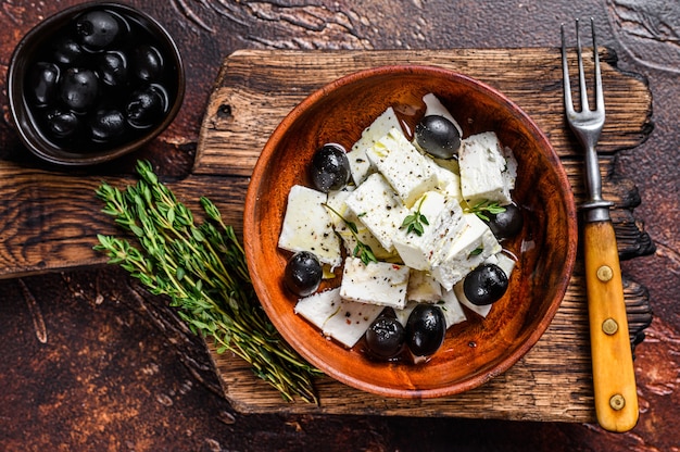 Salad with fresh feta cheese, thyme and olives.  Top view.