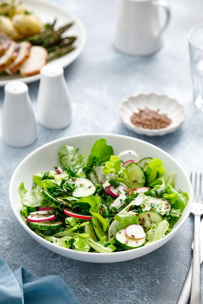 Salad with fresh green lettuce radish and cucumber