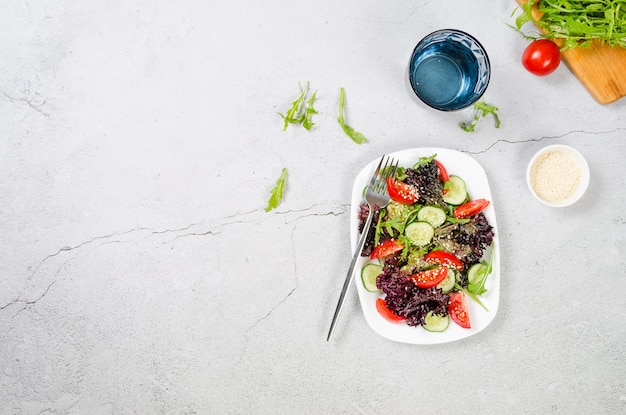 Salad with fresh salad leaves arugula cherry tomato cucomber