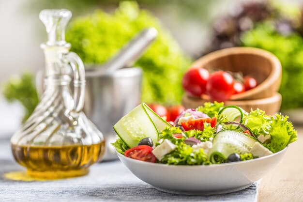 Salad with fresh vegetables olives tomatoes red onion greek cheese feta and olive oil.