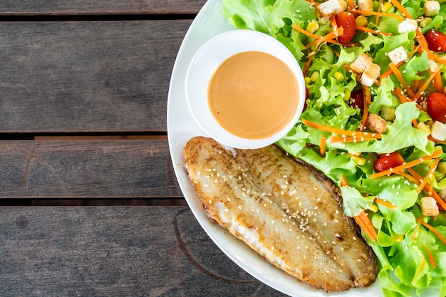 Salad with fried fish fillet