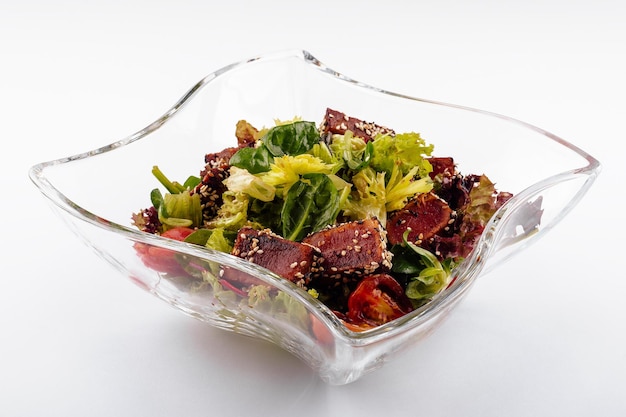 Salad with fried tuna on glass plate