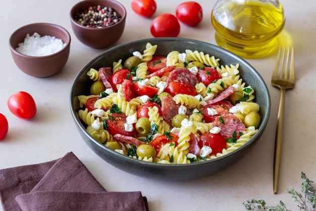 Salad with fusilli pasta sausage olives and cottage cheese Italian food