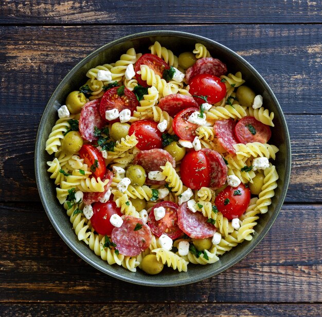 Salad with fusilli pasta sausage olives and cottage cheese Italian food