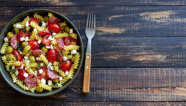 Salad with fusilli pasta sausage olives and cottage cheese Italian food