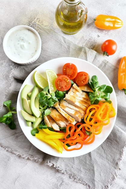 Photo salad with grilled chicken breast and fresh vegetables
