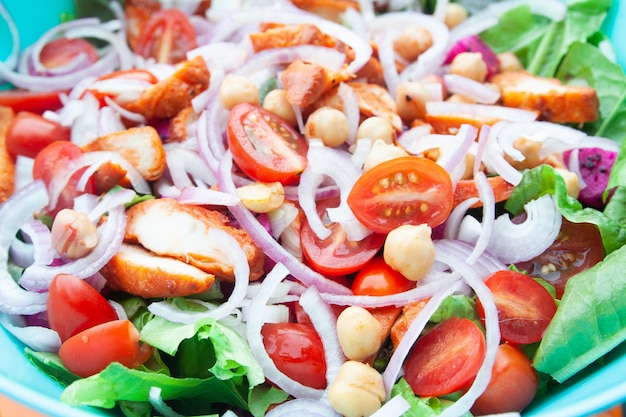 Salad with grilled chicken, cherry tomatoes, corn salad, chick peas, fresh lettuce and onion. 