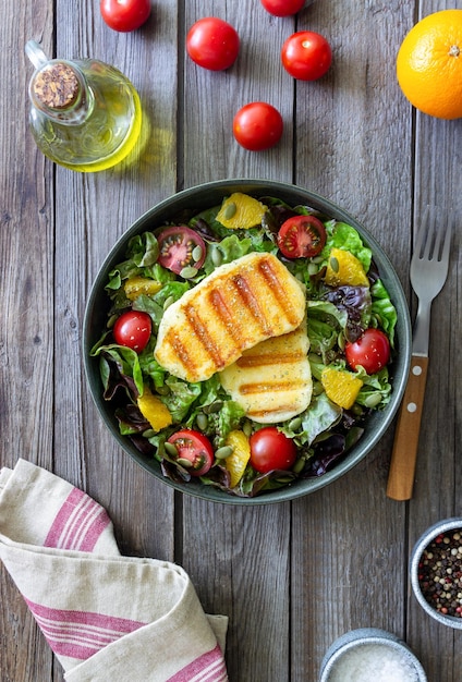 Salad with grilled halloumi cheese tomatoes orange and pumpkin seeds Healthy eating Vegetarian food Keto diet