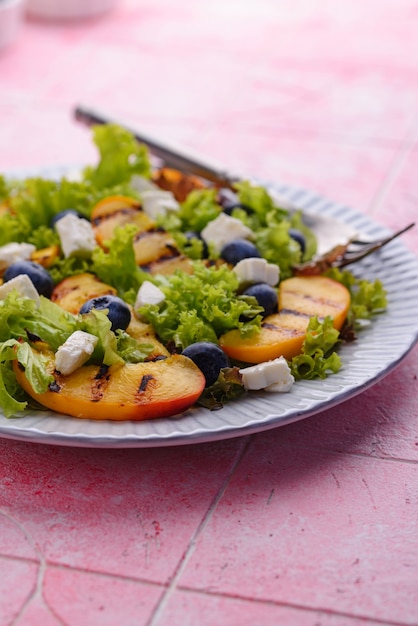 Salad with grilled peach blueberry and feta