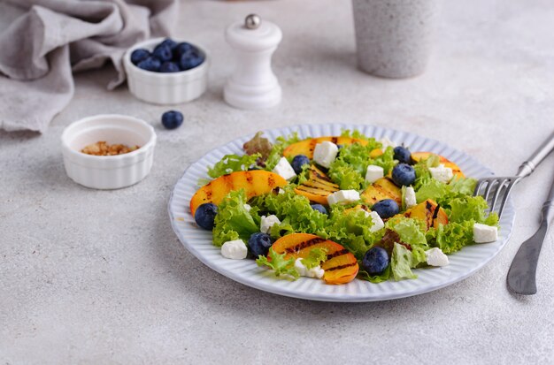 Salad with grilled peach blueberry and feta